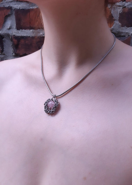 Handcrafted stinless steel chainmail  necklace with pink marble pendant worn on model outdoors